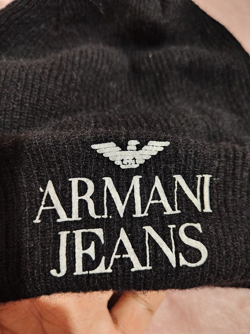Armani Jeans Black Wool Beanie Hat (Category: Beanies) located in Villasis. Submitted by trip_thrift15 (Listing ID 1468392317, Image 2). Description: - Brand: Armani Jeans - Color: Classic Black - Size: II - Design: White embroidered logo lettering and eagle detail on front cuff - Material: 80% Wool, 20% Nylon - Origin: Made in Italy - Care: Hand wash only - Condition: Excellent winter accessory MOP-GCASH/MAYA JNT COURIER PRICE+SF.