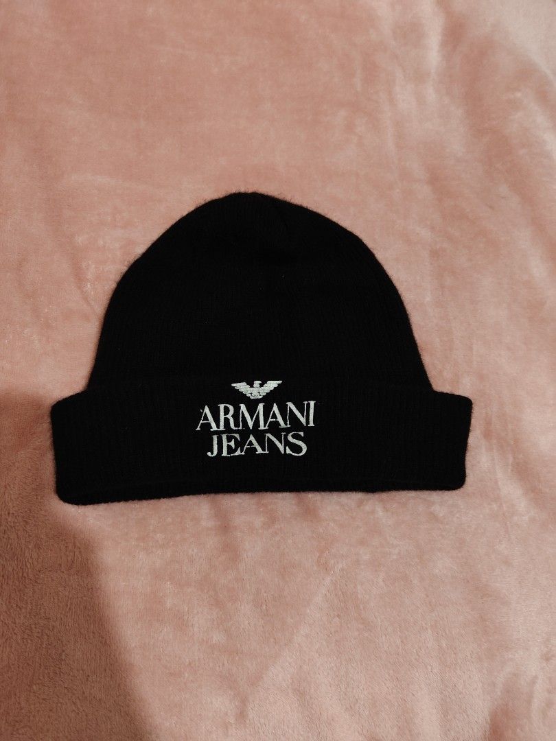 Armani Jeans Black Wool Beanie Hat (Category: Beanies) located in Villasis. Submitted by trip_thrift15 (Listing ID 1468392317, Image 1). Description: - Brand: Armani Jeans - Color: Classic Black - Size: II - Design: White embroidered logo lettering and eagle detail on front cuff - Material: 80% Wool, 20% Nylon - Origin: Made in Italy - Care: Hand wash only - Condition: Excellent winter accessory MOP-GCASH/MAYA JNT COURIER PRICE+SF.