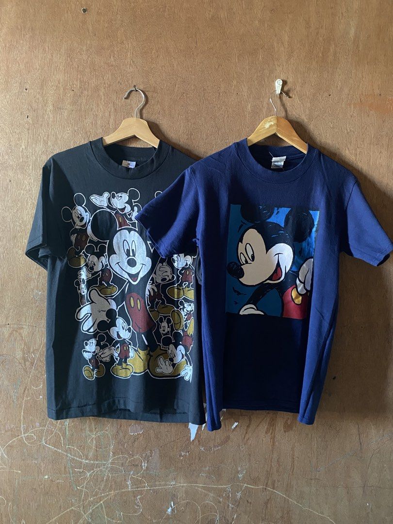 ASPACK!! 2 Vintage Mickey Mouse Shirt (Category: Activewear) located in Angeles City. Submitted by __vnsp (Listing ID 1468292782, Image 1). Description: - Authentic Disney Store graphic tee - Color: Navy blue with solid dark blue back - Design: Classic smiling Mickey Mouse art print on the front - Fit: Crew neck, short sleeves - Condition: Clean fabric with a nice vintage feel Negotiable.