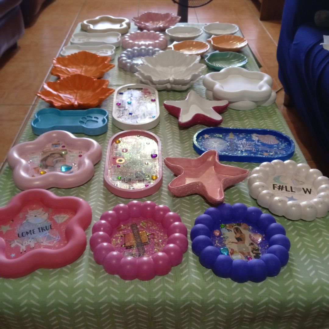Assorted Decorative Resin Trays and Dish Collection (Category: Dinnerware & Cutlery) located in Las Pinas. Submitted by deehlilah (Listing ID 1468309790, Image 2). Description: - Handmade resin & ceramic trinket trays, dishes, and plates - Available shapes: Starfish, leaves, dog bones, flowers, and photo frames - Beautiful glossy finishes featuring glitter, stickers, and decorative inserts - Perfect catch-all for jewelry, keys, and small accessor