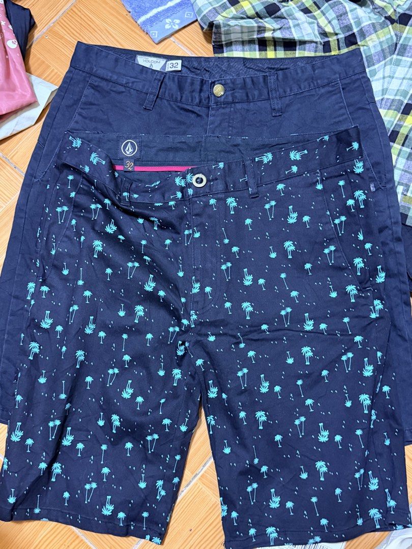 Assorted Men's Shorts Bundle Volcom Uniqlo Brands (Category: Shorts) located in Paete. Submitted by skydruemadison (Listing ID 1468302512, Image 2). Description: Bundle of men's shorts in various patterns and solid colors. Includes styles from Volcom and Uniqlo. Sizes include 32 and LL with adjustable waistbands or drawstrings. Variety of prints like plaid, tropical palm trees, and bandanas. Multiple utility pockets included on select pairs. Grea