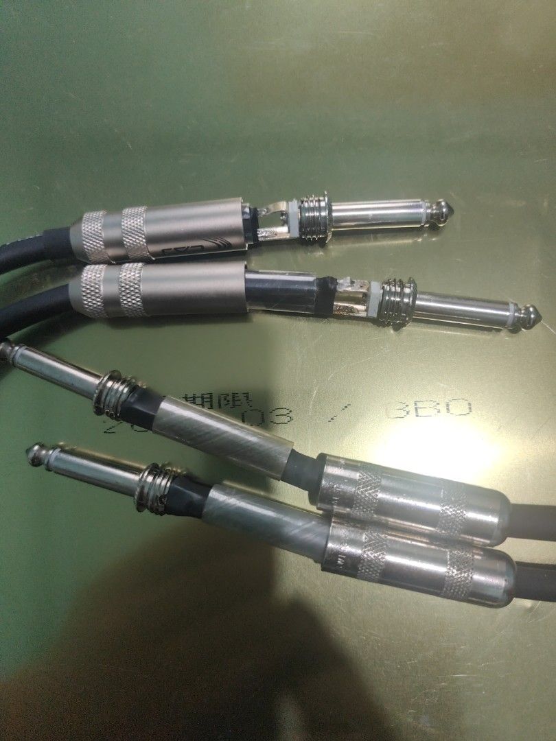 Audio Cables with 1/4 Inch Jack Connectors (Category: Cables & Adaptors) located in Manila. Submitted by wuxue998 (Listing ID 1468357365, Image 1). Description: - Type: Standard 1/4" mono jack audio cables - Build: Includes screw-on metal barrels and transparent heat shrink tubing for strain relief - Condition: Some outer barrels are unscrewed to show internal wiring/solder points (sold as pictured) - Best For: DIY audio setups, musical instrumen