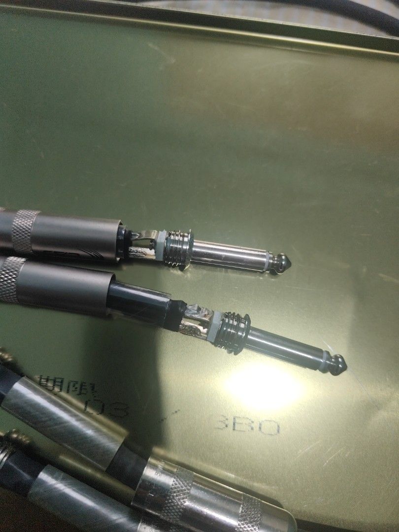 Audio Cables with 1/4 Inch Jack Connectors (Category: Cables & Adaptors) located in Manila. Submitted by wuxue998 (Listing ID 1468357365, Image 2). Description: - Type: Standard 1/4" mono jack audio cables - Build: Includes screw-on metal barrels and transparent heat shrink tubing for strain relief - Condition: Some outer barrels are unscrewed to show internal wiring/solder points (sold as pictured) - Best For: DIY audio setups, musical instrumen