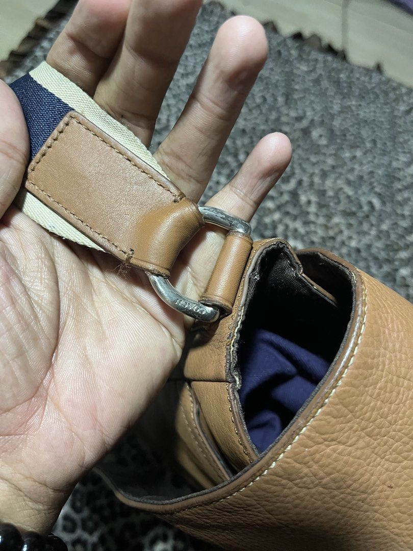 Authentic Coach Tan Leather Messenger Crossbody Bag (Category: Sling Bags) located in Manila. Submitted by becarria_thrift23 (Listing ID 1468387839, Image 2). Description: Authentic Coach flap messenger bag in tan leather with contrasting webbed shoulder strap. Complete with leather Creed patch and original hangtag.