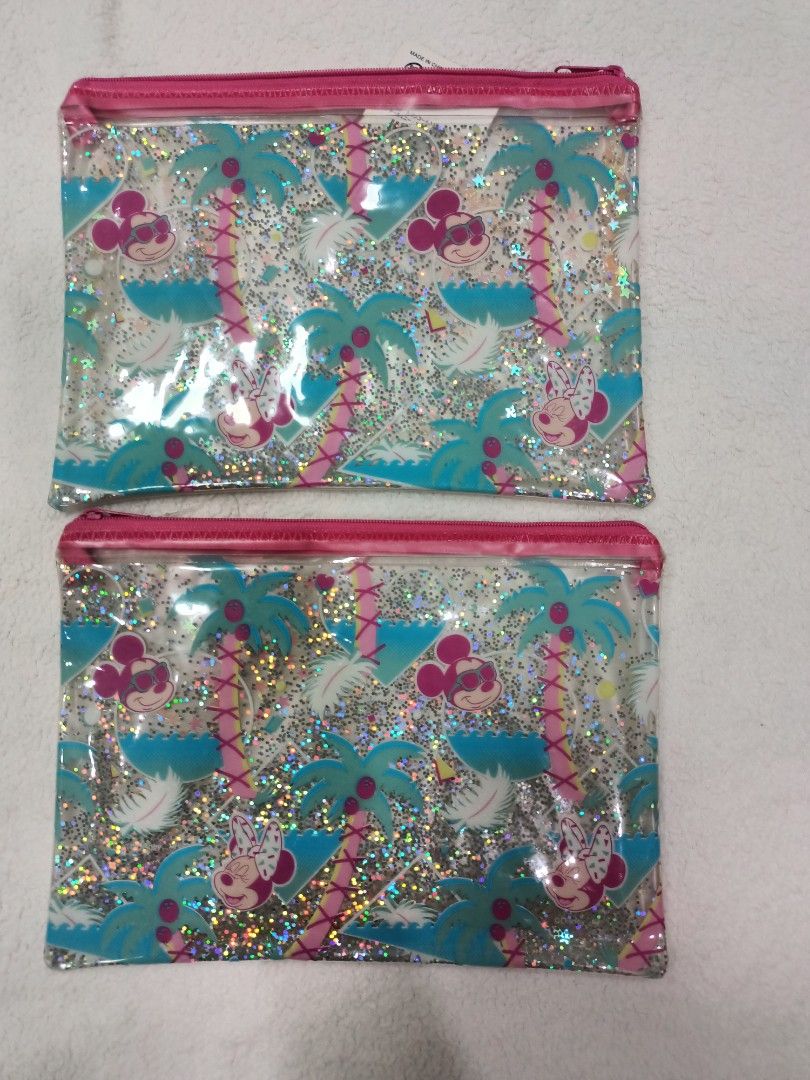 Authentic Disney Minnie Mouse Palm Tree Glitter Zipper Pouch (Category: Purses & Pouches) located in Manila. Submitted by jollynest24 (Listing ID 1468451822, Image 1). Description: - Authentic Minnie Mouse Glitter Zipper Pouch - Features a fun Minnie Mouse and tropical palm tree design - Filled with magical floating glitter confetti inside - Durable plastic material that is easy to wipe clean - Perfect for organizing makeup, school supplies, or t