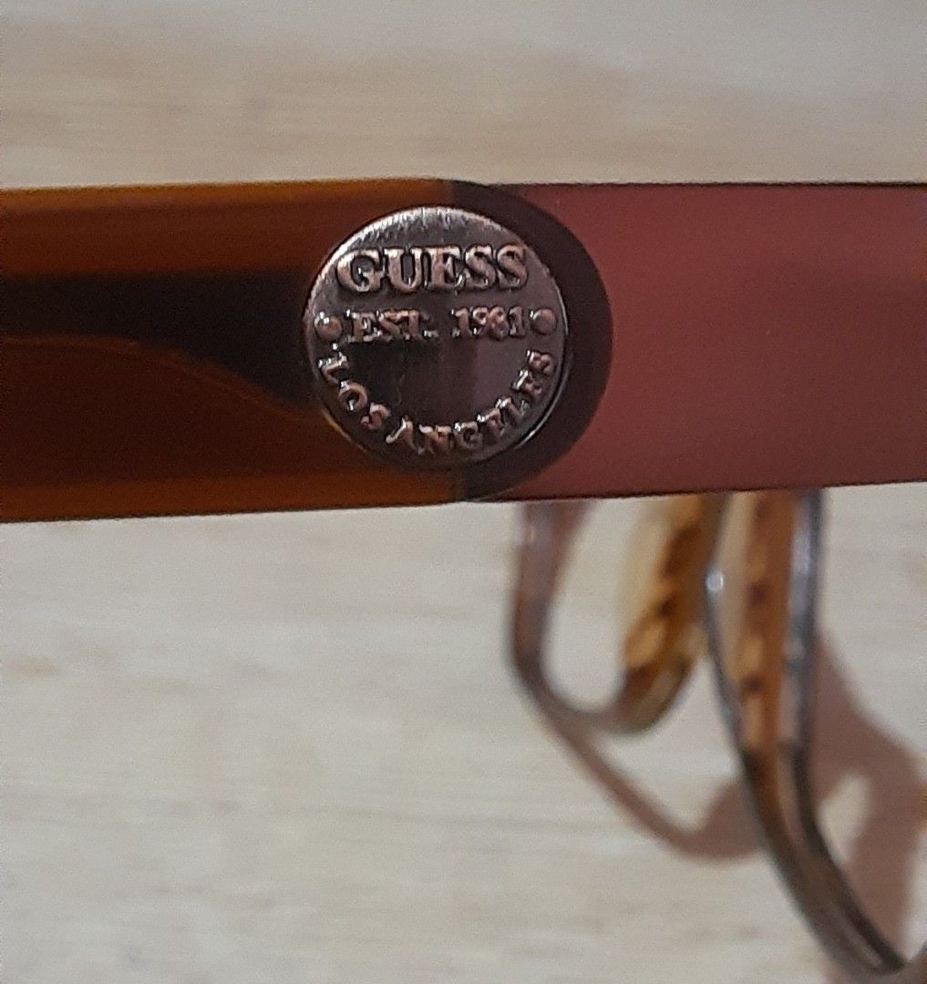 Authentic Guess Brown Eyeglasses Frame With Case (Category: Sunglasses & Eyewear) located in Manila. Submitted by crejzshoppe (Listing ID 1468325077, Image 3). Description: 52 -16-140 Frame only with original case lightly used in very good condition - Brand: Guess - Color/Pattern: Tortoise brown acetate - Shape: Classic rectangular - Details: Metal hardware medallion on temple with Guess Los Angeles branding - Inclusions: Original leopard print h