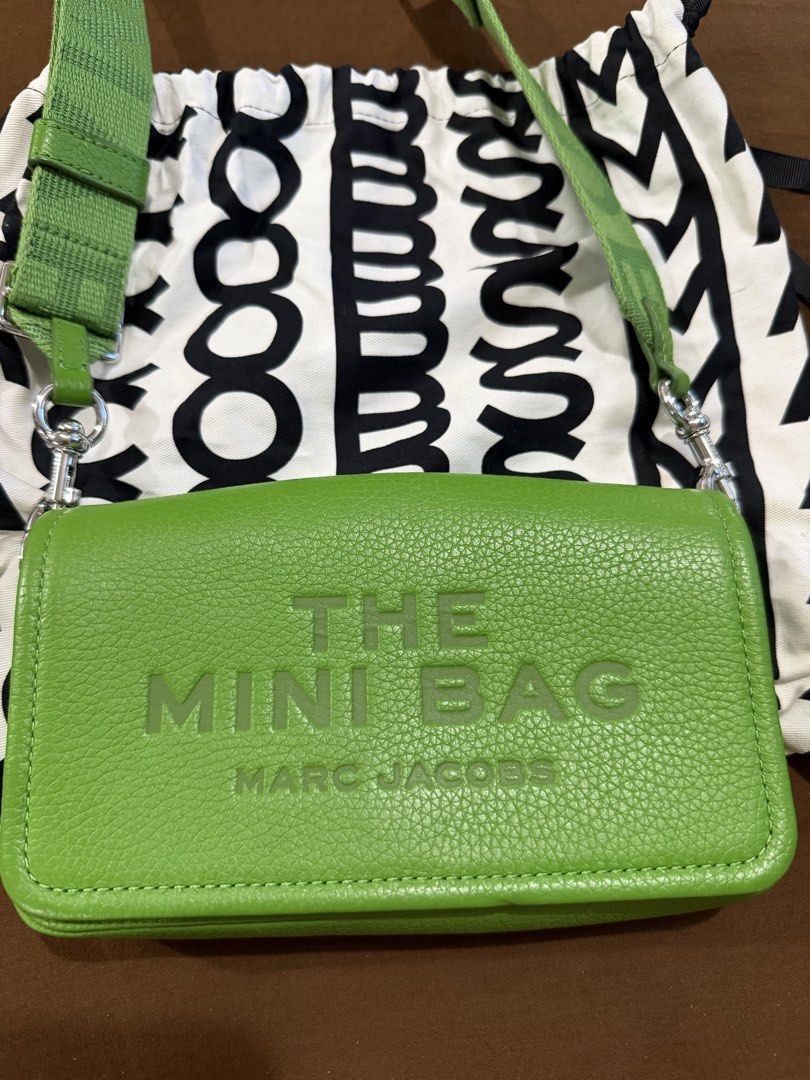 Authentic Marc Jacobs The Mini Bag Green (Category: Luxury Bags & Wallets) located in Quezon City. Submitted by rc1415 (Listing ID 1468356484, Image 3). Description: - Brand: Marc Jacobs - Style: Leather crossbody bag in a vibrant bright green shade - Exterior: Embossed 'THE MINI BAG' text on the front with silver-tone hardware - Interior: Vibrant yellow lining and a playful hidden quote 'MY OTHER BAG IS THE TOTE BAG' under the flap - Strap: Thic