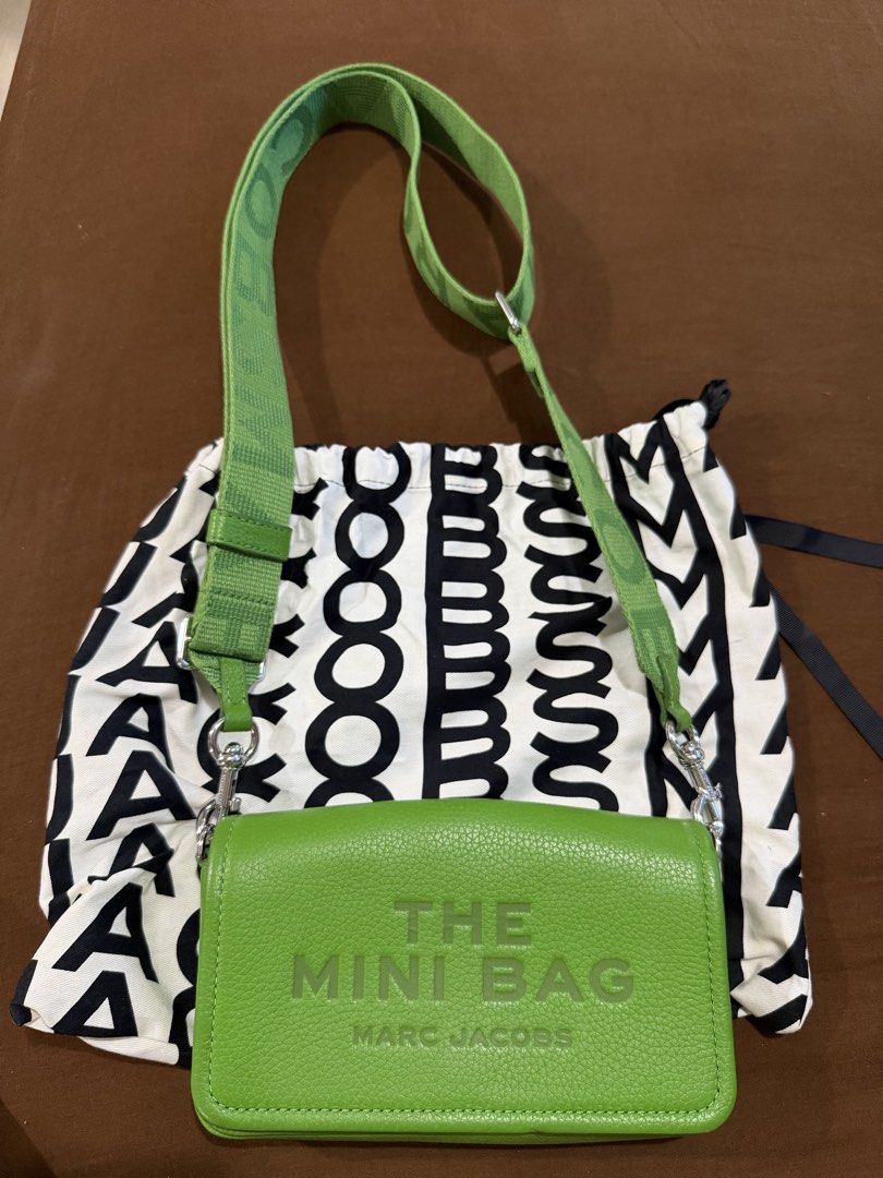 Authentic Marc Jacobs The Mini Bag Green (Category: Luxury Bags & Wallets) located in Quezon City. Submitted by rc1415 (Listing ID 1468356484, Image 1). Description: - Brand: Marc Jacobs - Style: Leather crossbody bag in a vibrant bright green shade - Exterior: Embossed 'THE MINI BAG' text on the front with silver-tone hardware - Interior: Vibrant yellow lining and a playful hidden quote 'MY OTHER BAG IS THE TOTE BAG' under the flap - Strap: Thic