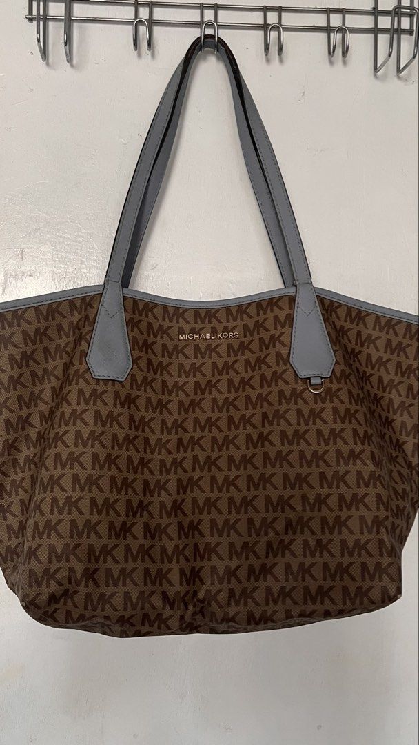 Authentic Michael Kors Tote Bag Brown Blue (Category: Tote Bags) located in Manila. Submitted by prelovedpick.com (Listing ID 1468292591, Image 1). Description: DECLUTTERING ‼️ FIXED PRICE - Authentic Michael Kors canvas tote bag with all-over MK monogram print - Elegant light blue leather straps and top trim - Premium gold-tone hardware, including front logo lettering and strap charm ring - Roomy interior compartment for your daily essentials - 