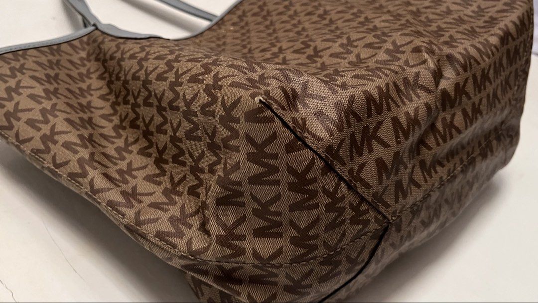 Authentic Michael Kors Tote Bag Brown Blue (Category: Tote Bags) located in Manila. Submitted by prelovedpick.com (Listing ID 1468292591, Image 3). Description: DECLUTTERING ‼️ FIXED PRICE - Authentic Michael Kors canvas tote bag with all-over MK monogram print - Elegant light blue leather straps and top trim - Premium gold-tone hardware, including front logo lettering and strap charm ring - Roomy interior compartment for your daily essentials - 