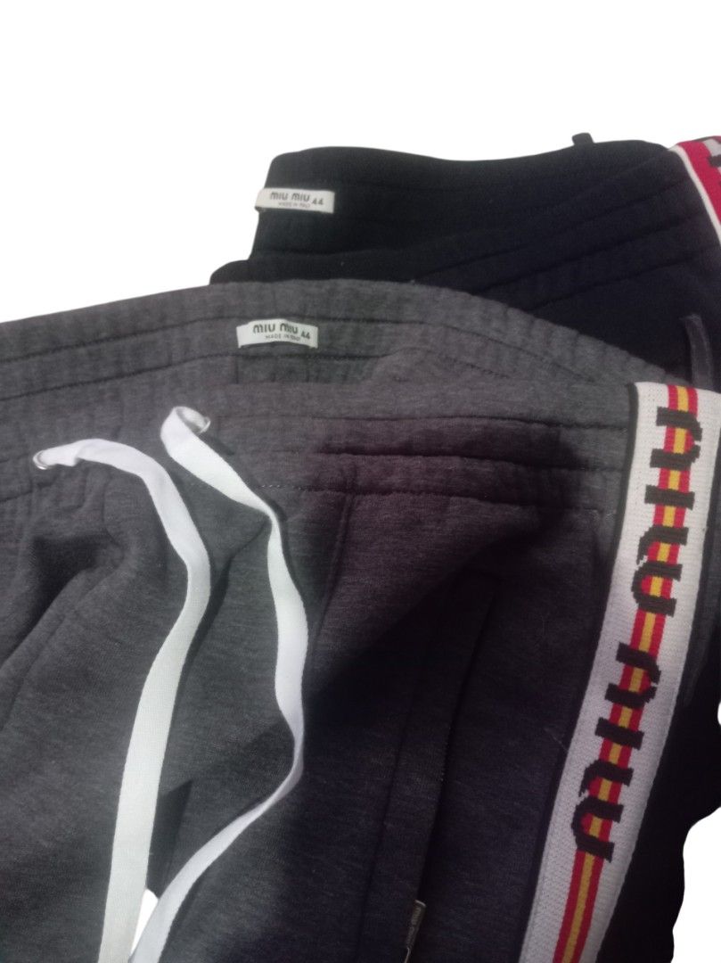 Authentic💯 MiuMiu 2pcs Jogger (Category: Luxury Apparel) located in Tagum. Submitted by maryjanepradalux (Listing ID 1468318090, Image 2). Description: Bundle of 2 authentic Miu Miu sweatpants in size 44 (Grey & Black). Made in Italy with cozy fleece, drawstring waist, zip pockets, and stylish logo side stripes. Super comfy and chic! Pm for more details .
