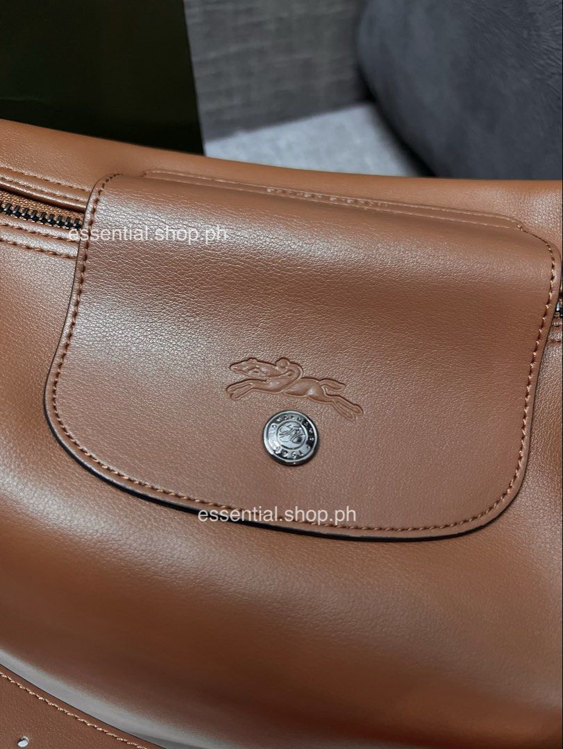 Authentic Preloved Longchamp Le Pliage Xtra M Hobo Cognac (Category: Luxury Bags & Wallets) located in Manila. Submitted by essential.shop.ph (Listing ID 1468472790, Image 3). Description: Preloved. Used a few times. Good as new but has an “aparador smell” because it was kept in storage for a long time. Actual color difficult to capture. ☺️ Authentic Longchamp Le Pliage Xtra Medium Hobo Cognac Includes dust bag, care card and paper bag. Dimension
