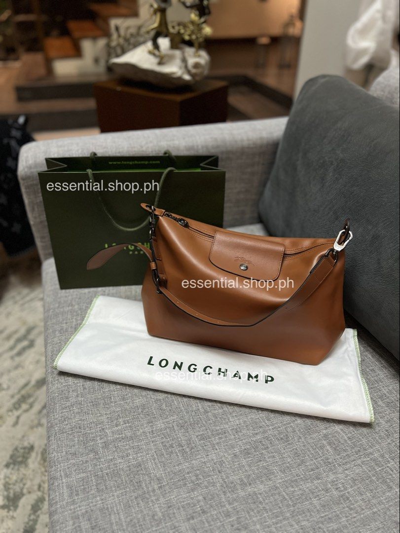 Authentic Preloved Longchamp Le Pliage Xtra M Hobo Cognac (Category: Luxury Bags & Wallets) located in Manila. Submitted by essential.shop.ph (Listing ID 1468472790, Image 1). Description: Preloved. Used a few times. Good as new but has an “aparador smell” because it was kept in storage for a long time. Actual color difficult to capture. ☺️ Authentic Longchamp Le Pliage Xtra Medium Hobo Cognac Includes dust bag, care card and paper bag. Dimension