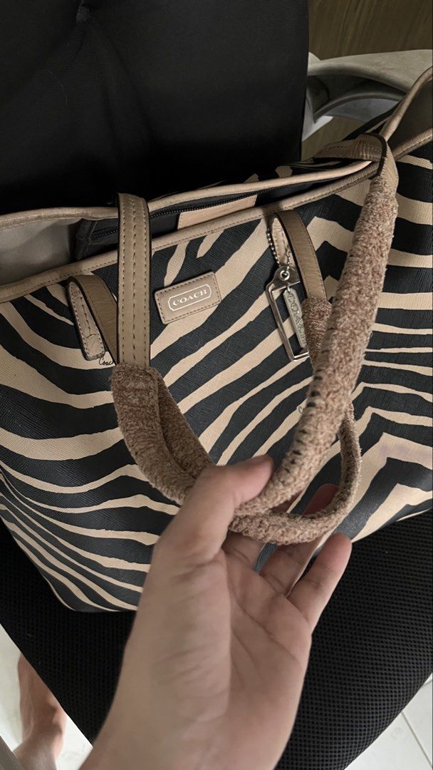 Authentic Rare Coach Zebra Print Tote Bag (Category: Luxury Bags & Wallets) located in Manila. Submitted by prelovedpick.com (Listing ID 1468308683, Image 1). Description: DECLUTTERING ‼️ FIXED PRICE WITH FREEBIES - Authentic Coach tote bag (Style: F26983) - Eye-catching zebra print pattern with beige leather trim and handles - Roomy interior with fabric lining and secure zip pocket - Includes signature metallic Coach hangtag - Comes with handle 