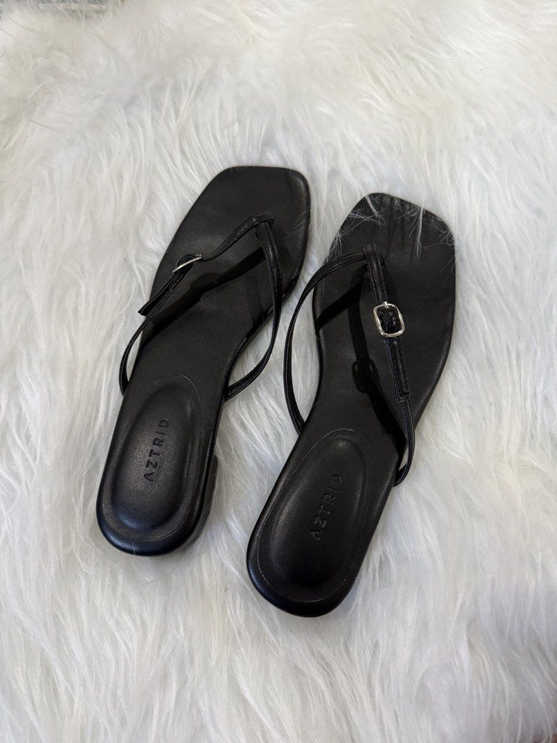 Aztrid Galen Black Sandals (Category: Flats & Sandals) located in Subic. Submitted by juls_mp (Listing ID 1468370488, Image 1). Description: - Brand: Aztrid Galen - Style: Black sandals with thin thong straps and small silver buckle detail - Shape & Heel: Modern square toe with a comfortable low block heel - Details: Clean footbed featuring the printed brand logo - Original Price: PHP 1698 - Versatility: Perfect for casual daily wear or dressing 