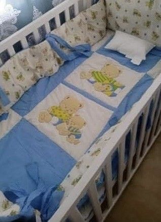 Baby Cot With Mattress and Bear Bedding Set (Category: Cots & Cribs) located in Las Pinas. Submitted by calmwolf_2a8740 (Listing ID 1468288486, Image 2). Description: - White wooden baby cot with a stylish natural wood top rail - Includes a comfortable mattress and adorable blue-and-white teddy bear bedding set (bumpers and pillows included) - Slatted sides for safety and optimal airflow - Sturdy metal wire mattress support base - Clean and well-