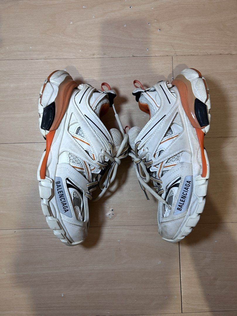 Balenciaga Track Sneaker White Orange Size 35 (Category: Sneakers) located in Dipolog. Submitted by adrian281994 (Listing ID 1468411096, Image 3). Description: - Brand: Balenciaga Track Sneakers - Colorway: White and Orange with matching inner lining and heel loop - Size: 35 (marked on toe and tongue pull tab) - Design: Chunky multi-panel layered mesh and nylon upper - Sole: Complex rubber sole with trendy distressed detailing - Details: Signatur