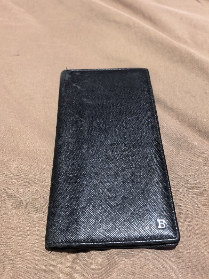 Bally Black Leather Long Wallet (Category: Luxury Bags & Wallets) located in Manila. Submitted by cura.ta88 (Listing ID 1468397863, Image 1). Description: - Brand: Bally - Material: Black saffiano leather - Hardware: Silver-tone metal 'B' logo on front - Features: Multiple card slots, slip pockets, and a spacious bill compartment - Condition: Exterior has normal signs of wear and surface scuffs near the top edge; interior is clean and all pockets