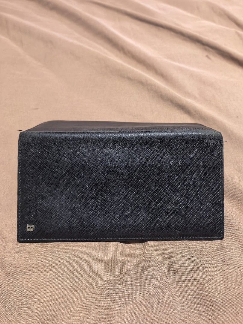 Bally Black Leather Long Wallet (Category: Luxury Bags & Wallets) located in Manila. Submitted by cura.ta88 (Listing ID 1468397863, Image 3). Description: - Brand: Bally - Material: Black saffiano leather - Hardware: Silver-tone metal 'B' logo on front - Features: Multiple card slots, slip pockets, and a spacious bill compartment - Condition: Exterior has normal signs of wear and surface scuffs near the top edge; interior is clean and all pockets