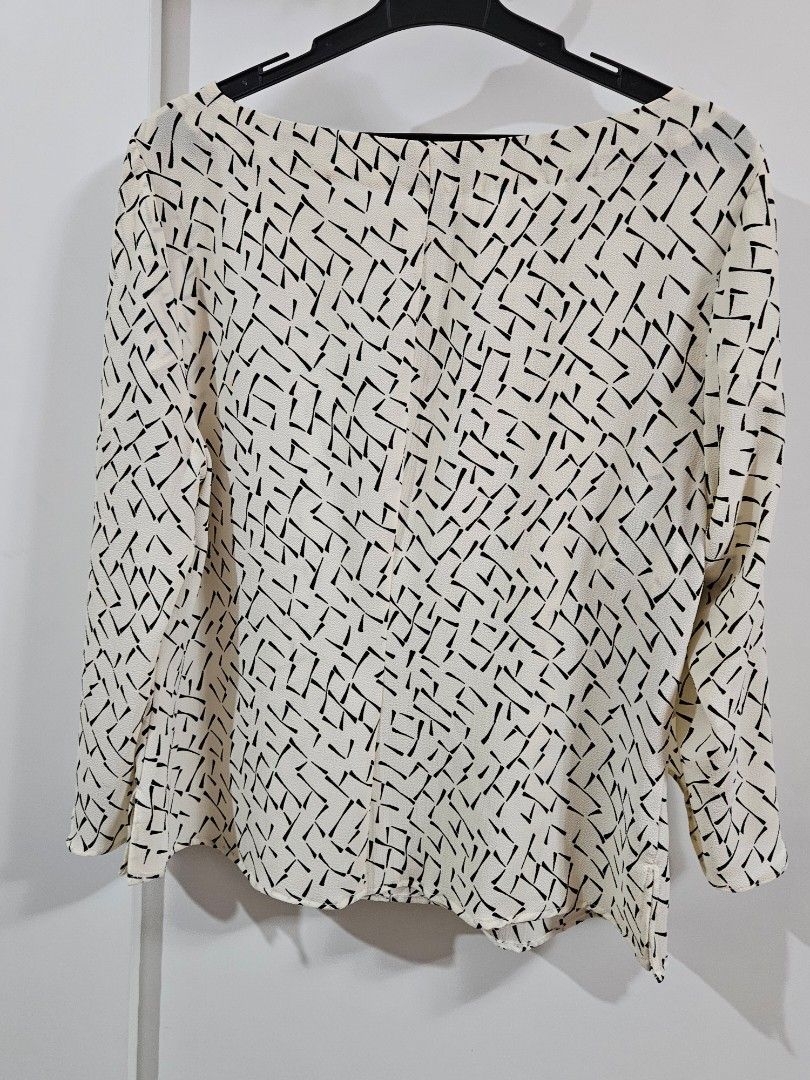 Banana Republic Printed Blouse Size M (Category: Blouses) located in Caloocan City. Submitted by rm.diaz (Listing ID 1468295455, Image 3). Description: - Brand: Banana Republic - Style: Long sleeve blouse with round neckline - Color/Pattern: Cream with black geometric abstract design - Size: Medium (tag attached) - Material: Lightweight textured fabric - Origin: Made in China - Condition: Brand new with tags / Excellent - Perfect for: Workwear, s