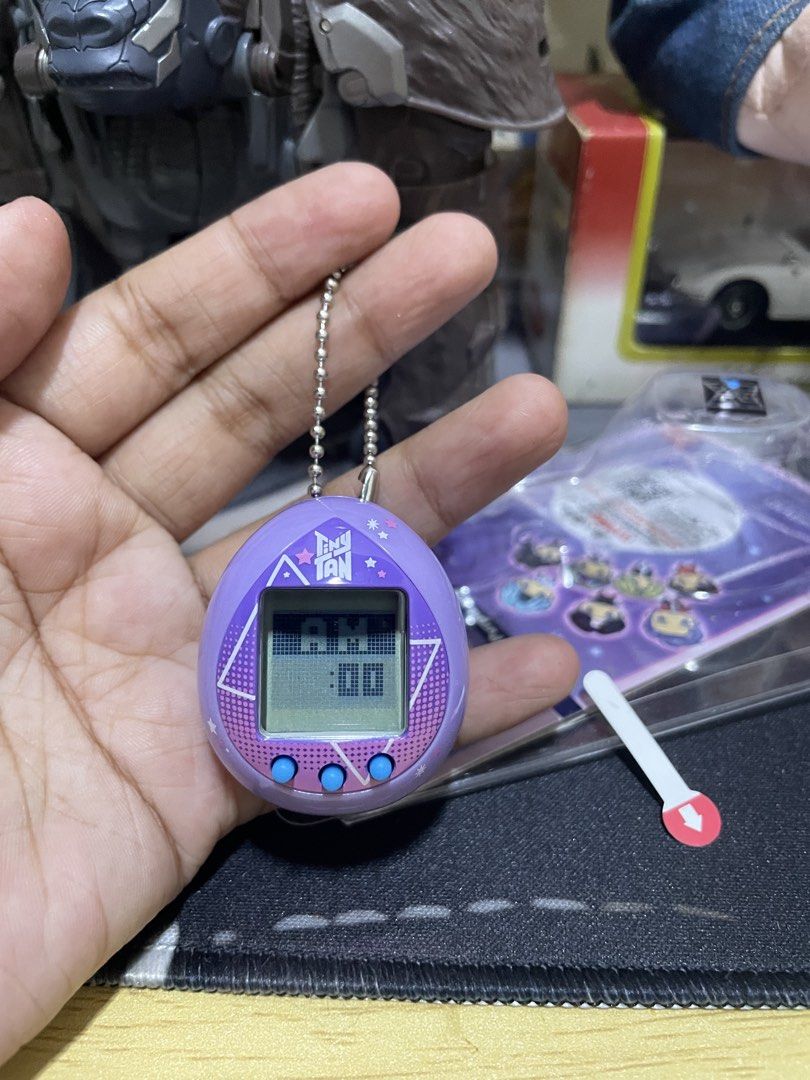 Bandai Pui Pui Molcar & TinyTAN Tamagotchi Bundle (Category: Interactive Toys) located in Agdangan. Submitted by kuradekawaii_06 (Listing ID 1468400703, Image 3). Description: - Set of 2 authentic Bandai Tamagotchi virtual pets - Variants: Pui Pui Molcar Driving School Ver. (Blue) and TinyTAN Purple Ver. - Condition: Like new, taken out of packaging for photos only - Screen tested: Battery tabs pulled to test screens, original pull tabs included 