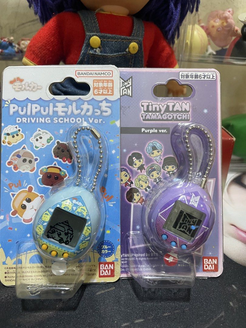 Bandai Pui Pui Molcar & TinyTAN Tamagotchi Bundle (Category: Interactive Toys) located in Agdangan. Submitted by kuradekawaii_06 (Listing ID 1468400703, Image 1). Description: - Set of 2 authentic Bandai Tamagotchi virtual pets - Variants: Pui Pui Molcar Driving School Ver. (Blue) and TinyTAN Purple Ver. - Condition: Like new, taken out of packaging for photos only - Screen tested: Battery tabs pulled to test screens, original pull tabs included 