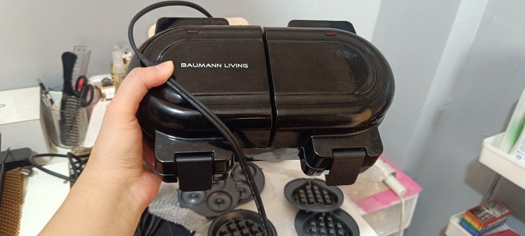 Baumann Living Dual Multi Snack Maker (Category: Cookware & Accessories) located in Las Pinas. Submitted by andielle_0121 (Listing ID 1468346718, Image 3). Description: - Brand: Baumann Living Dual Multi Snack Maker Original Price: 3,500 (check orange app) negotiable po ang 2500 if sure buyer i can lessen it to 2k na lang po - Color: Sleek Black - Features: Dual cooking slots with interchangeable plates for waffles, donuts, pancakes, and eggs - C