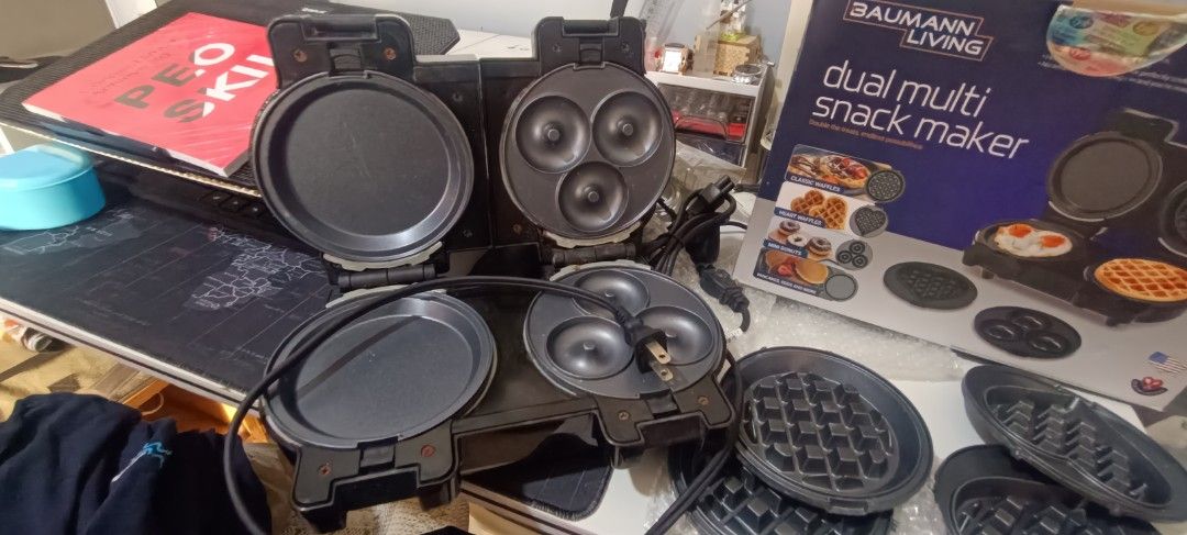 Baumann Living Dual Multi Snack Maker (Category: Cookware & Accessories) located in Las Pinas. Submitted by andielle_0121 (Listing ID 1468346718, Image 2). Description: - Brand: Baumann Living Dual Multi Snack Maker Original Price: 3,500 (check orange app) negotiable po ang 2500 if sure buyer i can lessen it to 2k na lang po - Color: Sleek Black - Features: Dual cooking slots with interchangeable plates for waffles, donuts, pancakes, and eggs - C