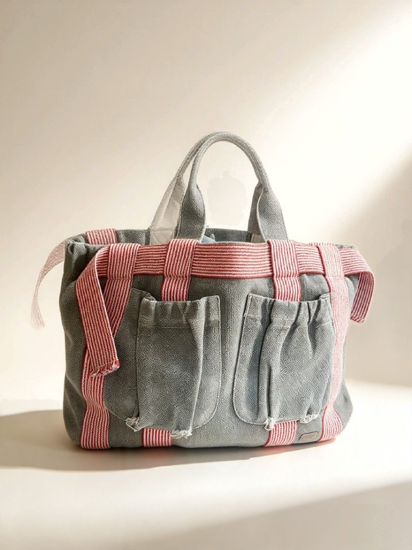 BAYO Canvas Tote Bag Grey Red Striped (Category: Tote Bags) located in Batangas. Submitted by mace2014 (Listing ID 1468323712, Image 1). Description: - Brand: BAYO - Material: Durable grey canvas with structured bottom to hold shape - Straps: Eye-catching red and white striped dual top handles - Pockets: Two front pockets with trendy frayed distressing and convenient side compartments - Usage: Spacious casual everyday bag with plenty of room insi