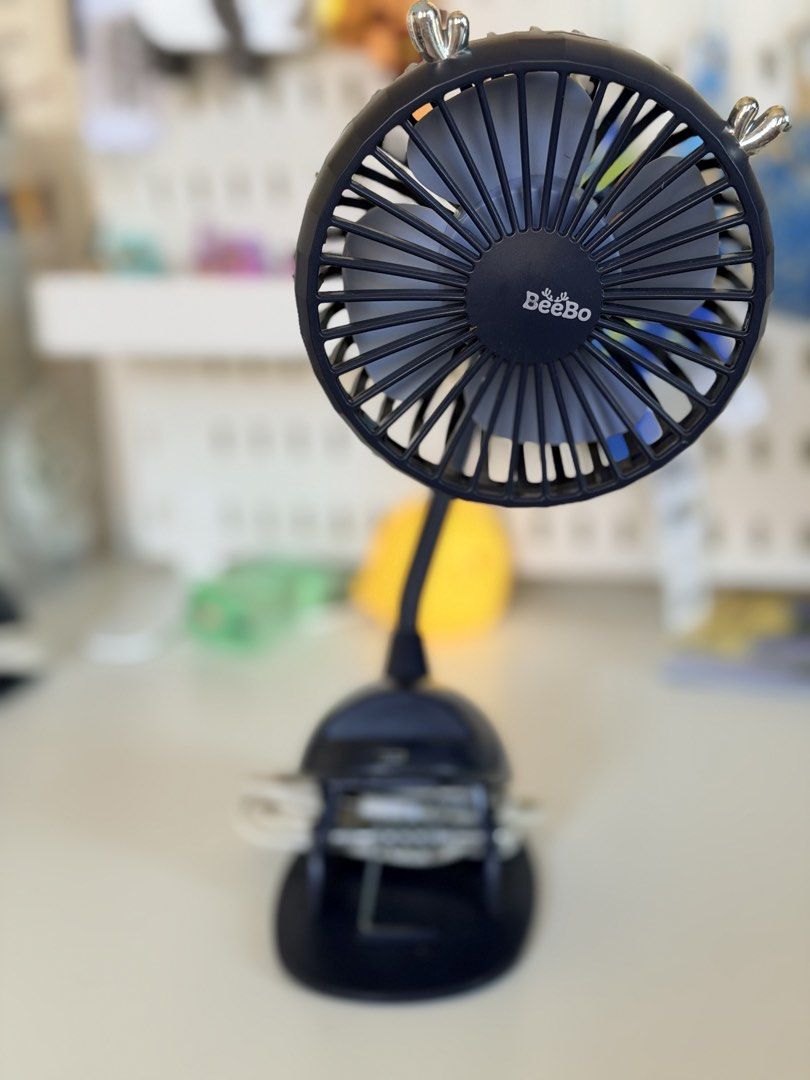 BeeBo Dark Blue Clip-On Fan (Category: Other Kids Furniture) located in Paranaque City. Submitted by sweetiesarah01 (Listing ID 1468355221, Image 1). Description: - Brand: BeeBo - Color: Dark blue - Type: Clip-on fan with flexible gooseneck stem - Power: USB charging cable included - Features: Sturdy base clip for desks/shelves, simple back control buttons for power and speed - Condition: Tested and works well - Ideal for: Baby Stroller or Car Se