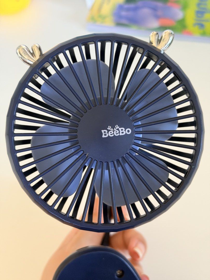 BeeBo Dark Blue Clip-On Fan (Category: Other Kids Furniture) located in Paranaque City. Submitted by sweetiesarah01 (Listing ID 1468355221, Image 2). Description: - Brand: BeeBo - Color: Dark blue - Type: Clip-on fan with flexible gooseneck stem - Power: USB charging cable included - Features: Sturdy base clip for desks/shelves, simple back control buttons for power and speed - Condition: Tested and works well - Ideal for: Baby Stroller or Car Se