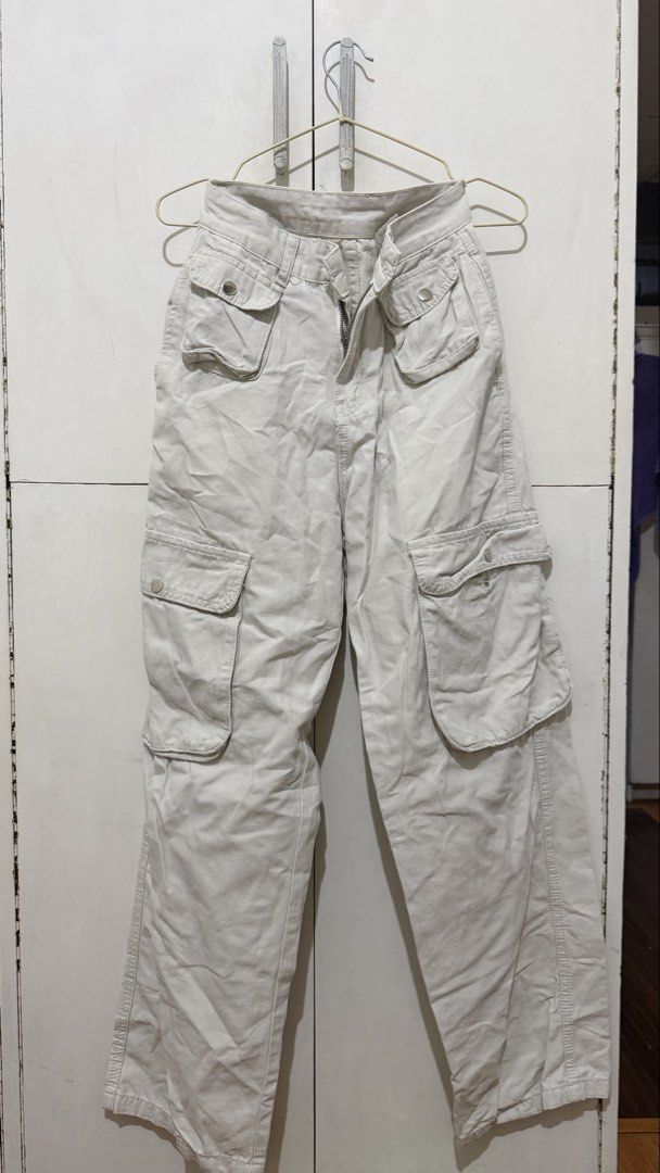 Beige Cargo Pants Y2K Utility Trousers (Category: Jeans) located in Taguig. Submitted by deguzmanke83356 (Listing ID 1468361181, Image 1). Description: - Color: Beige - Style: Utility cargo pants with straight leg cut and mid to high rise waist - Material: Sturdy twill fabric featuring contrast stitching - Pockets: Multiple front and side pockets with snap-button closures, plus two back welt pockets - Closure: Zip fly with button closure - Perfec