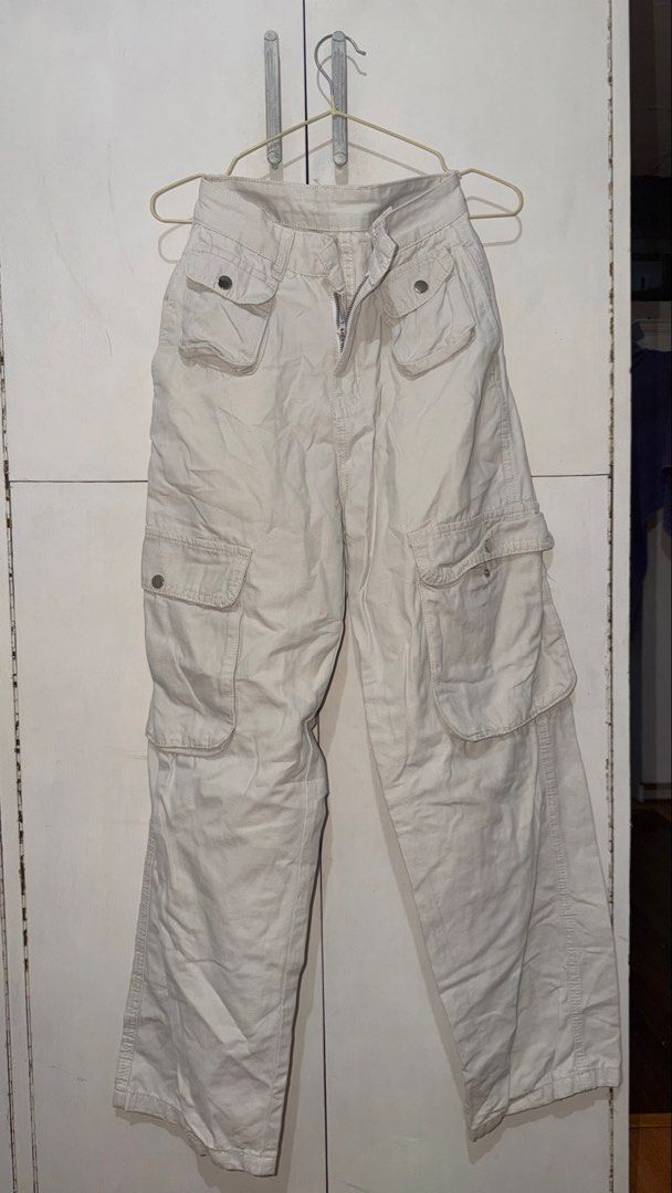 Beige Cargo Pants Y2K Utility Trousers (Category: Jeans) located in Taguig. Submitted by deguzmanke83356 (Listing ID 1468361181, Image 2). Description: - Color: Beige - Style: Utility cargo pants with straight leg cut and mid to high rise waist - Material: Sturdy twill fabric featuring contrast stitching - Pockets: Multiple front and side pockets with snap-button closures, plus two back welt pockets - Closure: Zip fly with button closure - Perfec