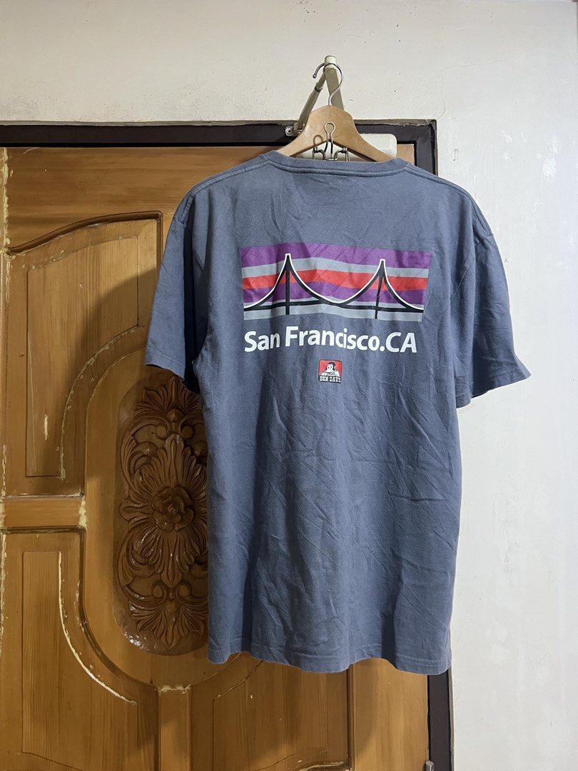 Ben Davis San Francisco CA Graphic T-shirt Grey (Category: Tshirts & Polo Shirts ) located in Valencia. Submitted by thrifttomaniac_1225 (Listing ID 1468302354, Image 2). Description: - Brand: Ben Davis - Color: Grey - Size: Small - Design: Small box logo on chest, large San Francisco bridge graphic on the back - Fit: Standard fit with crew neck and short sleeves - Material: 100% soft cotton - Condition: Excellent / Brand New - Perfect for casual