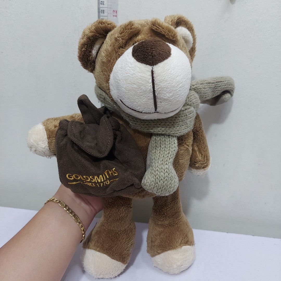 Goldsmiths Bertie the Bear 2007 Anniversary Edition 12" Plush Toy with Scarf and Bag Collectible Gift (Category: Plushies & Soft Toys) located in Pasig City. Submitted by muffinstoysshop (Listing ID 1468373204, Image 2). Description: Goldsmiths Bertie the Bear 2007 Anniversary Edition 12" Plush Toy with Scarf and Bag Collectible Gift - Size : 12 - INCH / 30 cm - Brand : GoldSmiths - Quantity: 1 pc - Good as new - Cleaned & Sanitized - Good Condit