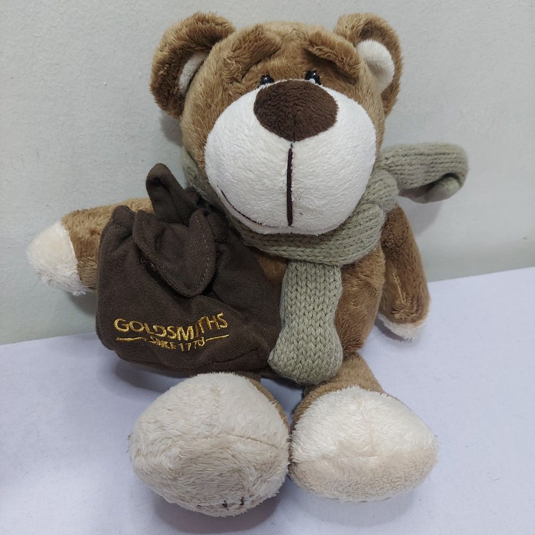 Goldsmiths Bertie the Bear 2007 Anniversary Edition 12" Plush Toy with Scarf and Bag Collectible Gift (Category: Plushies & Soft Toys) located in Pasig City. Submitted by muffinstoysshop (Listing ID 1468373204, Image 3). Description: Goldsmiths Bertie the Bear 2007 Anniversary Edition 12" Plush Toy with Scarf and Bag Collectible Gift - Size : 12 - INCH / 30 cm - Brand : GoldSmiths - Quantity: 1 pc - Good as new - Cleaned & Sanitized - Good Condit