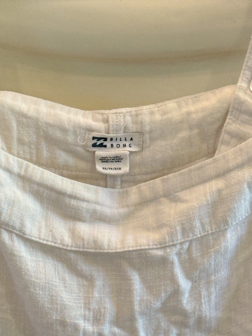 Billabong white linen sundress (Category: Dresses) located in Angeles City. Submitted by adeclutters__ (Listing ID 1468341490, Image 3). Description: - Brand: Billabong - Size: XS - Color: White - Origin: Made in India - Material: Lightweight and breathable - Design: Square neckline, thick straps, pleated bodice, and back button closure - Style: Simple, versatile, perfect for beach days, warm weather, and casual outings Bought at 2000 Selling at 