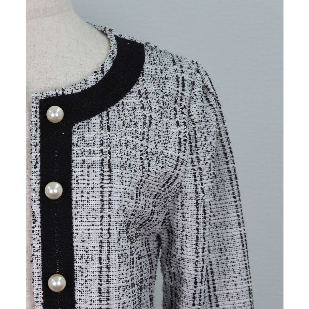 Black and White Tweed Pearl Button Jacket (Category: Coats, Jackets and Outerwear) located in Quezon City. Submitted by cuteitemsonlyyy (Listing ID 1468434169, Image 2). Description: Black and white tweed jacket with contrasting black trim along the neckline and front placket. Styled with faux pearl dome buttons down the front. Long sleeves with structured shoulders. Textured fabric. Easy to layer over blouses and tops for a dressed-up look..