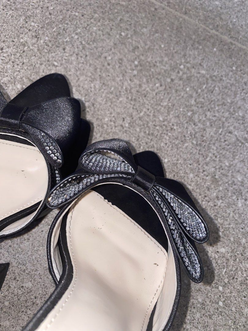 Black Bow Platform Heels Size 37 (Category: Heels) located in Pasay City. Submitted by violetttttttttttttt (Listing ID 1468356352, Image 3). Description: - Style: Platform heels with pointed toes and chunky block heels - Material: Satin-like fabric finish in classic black - Details: Eye-catching rhinestone-studded bow and adjustable ankle straps - Size: 37 - Condition: like new.