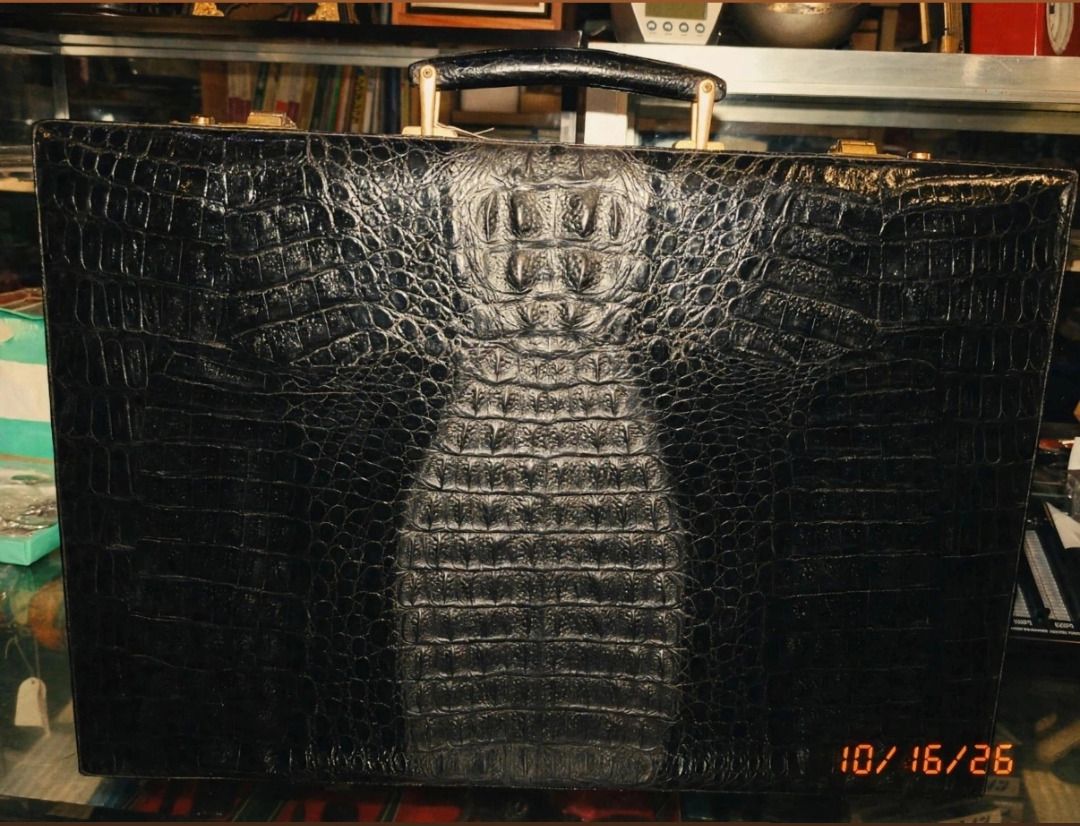 Black Crocodile Leather Briefcase (Category: Briefcases) located in Tarlac. Submitted by jeremiah.curator.2026 (Listing ID 1468435789, Image 1). Description: - Material: Black crocodile leather with a textured hide pattern - Design: Structured hard body with clean edge stitching - Features: Sturdy top handle and secure metal hardware closures - Style: Classic, professional, and full of character.