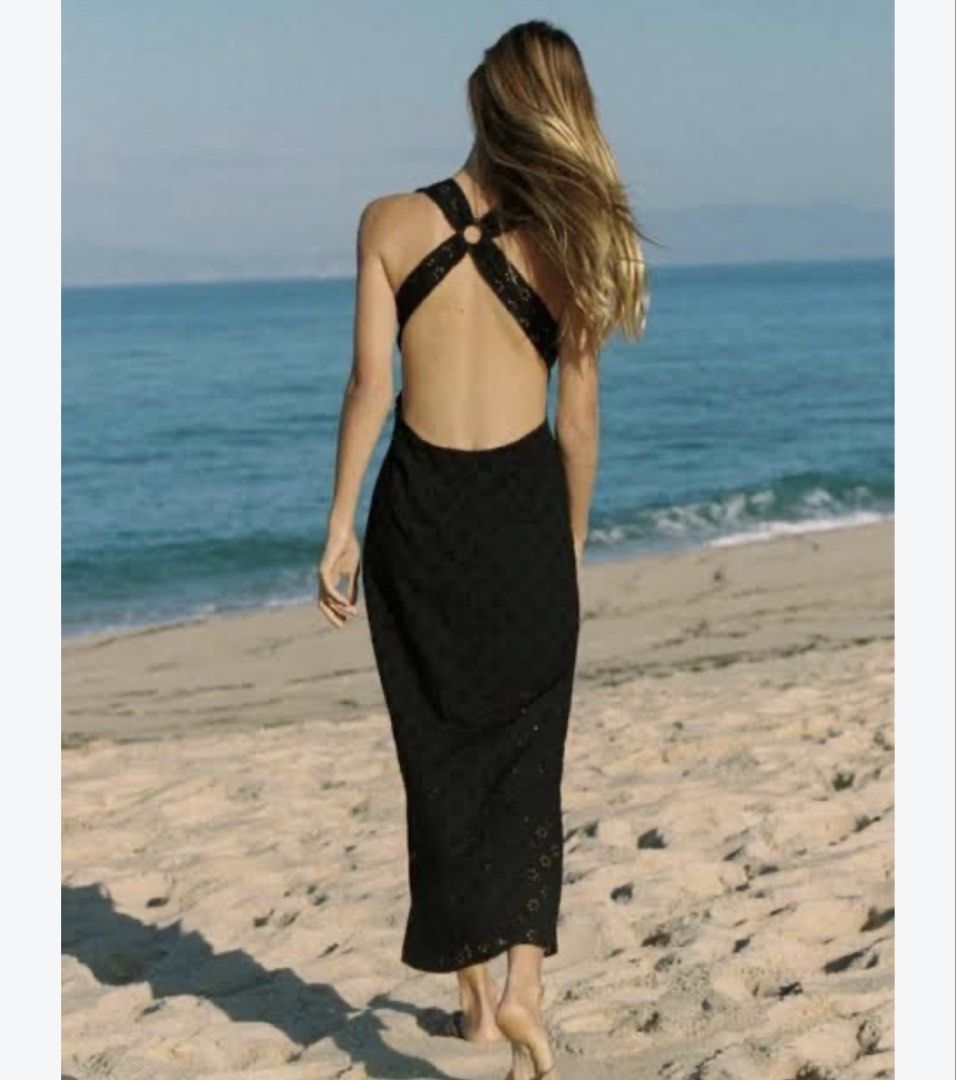 Black eyelet maxi dress with halter open back (Category: Dresses) located in Quezon City. Submitted by gwy_preloved (Listing ID 1468306399, Image 3). Description: - Style: Black eyelet maxi dress with embroidered floral pattern - Design: Deep V-neckline, open back, halter straps with ring detail, and patterned hem - Material: Lightweight and comfortable fabric - Occasion: Perfect for summer beach trips or evening outings - Fit: Full length, easy 