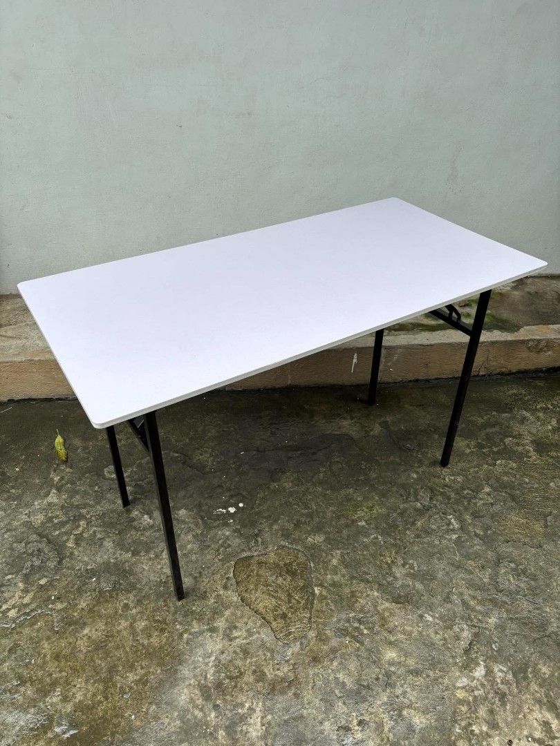 Black Folding Utility Table with Metal Legs (Category: Tables & Sets) located in Manila. Submitted by ajimdolor012051 (Listing ID 1468326232, Image 3). Description: - Rectangular table with a sleek black top and reddish-brown wood finish underneath - Sturdy black metal folding legs for easy storage and transport - Stable and reliable setup on any flat surface - Ideal extra surface for studying, working, dining, or hosting gatherings - Space-savin