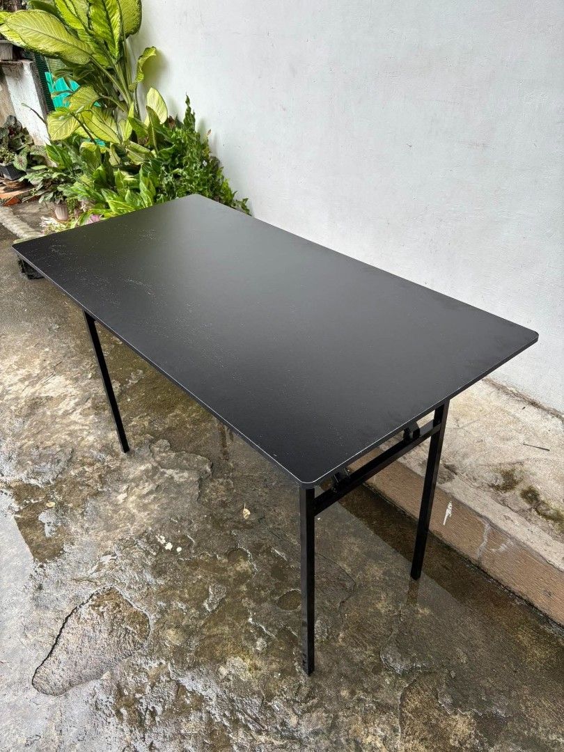 Black Folding Utility Table with Metal Legs (Category: Tables & Sets) located in Manila. Submitted by ajimdolor012051 (Listing ID 1468326232, Image 1). Description: - Rectangular table with a sleek black top and reddish-brown wood finish underneath - Sturdy black metal folding legs for easy storage and transport - Stable and reliable setup on any flat surface - Ideal extra surface for studying, working, dining, or hosting gatherings - Space-savin