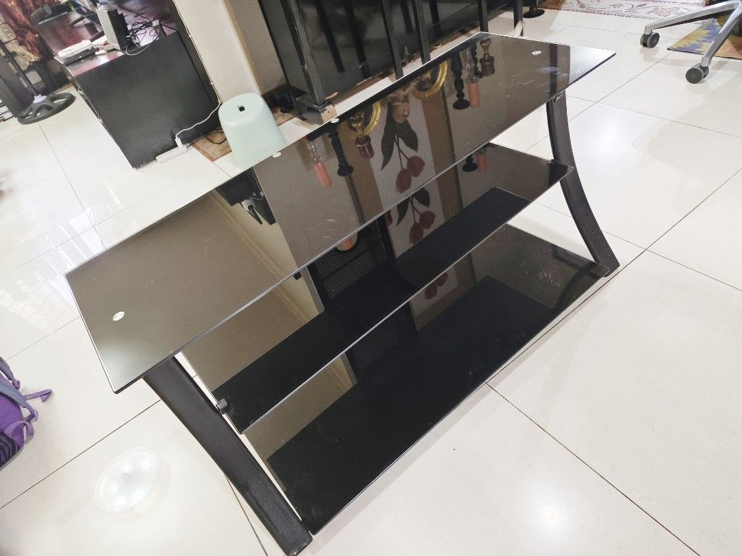 Black glass TV console with three tiers (Category: TV Consoles) located in Pasig City. Submitted by maming73 (Listing ID 1468305052, Image 2). Description: - 3-tier black glass TV console - Dark-tinted tempered glass shelves - Sturdy curved side legs - Ideal for TVs, game consoles, and soundbars - Standard size for living rooms or bedrooms - Pick up only due to weight and glass material call or text 09178535696.
