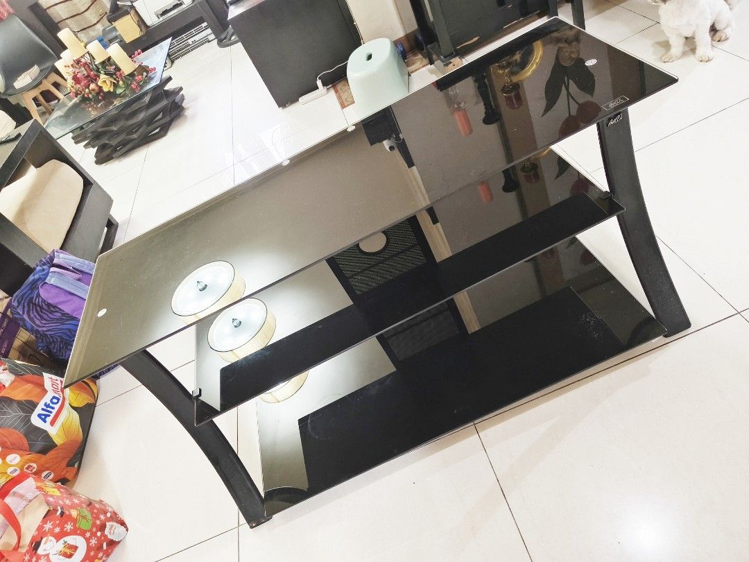 Black glass TV console with three tiers (Category: TV Consoles) located in Pasig City. Submitted by maming73 (Listing ID 1468305052, Image 1). Description: - 3-tier black glass TV console - Dark-tinted tempered glass shelves - Sturdy curved side legs - Ideal for TVs, game consoles, and soundbars - Standard size for living rooms or bedrooms - Pick up only due to weight and glass material call or text 09178535696.
