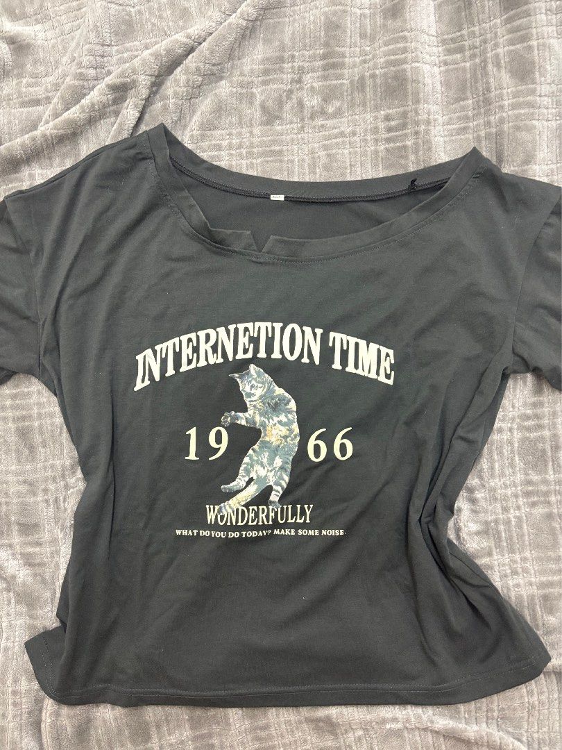 Black Graphic Cat T-Shirt (Category: Shirts) located in Cavite. Submitted by xxjxt (Listing ID 1468408193, Image 1). Description: - Color: Dark grey - Design: Center cat graphic with 'INTERNETION TIME 1966 WONDERFULLY' text - Style: Casual everyday short-sleeve top - Material: Soft cotton feel - Versatile: Easy to pair with jeans or shorts - Condition: Brand new / Excellent.