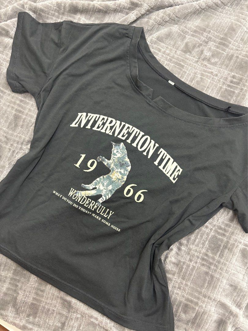 Black Graphic Cat T-Shirt (Category: Shirts) located in Cavite. Submitted by xxjxt (Listing ID 1468408193, Image 2). Description: - Color: Dark grey - Design: Center cat graphic with 'INTERNETION TIME 1966 WONDERFULLY' text - Style: Casual everyday short-sleeve top - Material: Soft cotton feel - Versatile: Easy to pair with jeans or shorts - Condition: Brand new / Excellent.