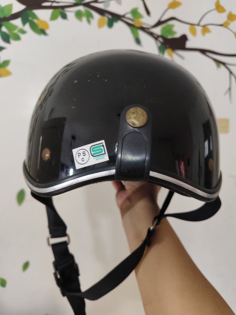 Black Half Shell Motorcycle Helmet (Category: Caps & Hats) located in Bulacan. Submitted by babz30261 (Listing ID 1468440276, Image 3). Description: - Color/Finish: Glossy black with stylish silver trim - Safety: Certified with PSC and S safety standard stickers - Fit & Comfort: Adjustable black chin strap with a convenient quick-release buckle - Condition: Some minor scuffs on the outer shell from normal use, but structurally solid - Ideal For: 