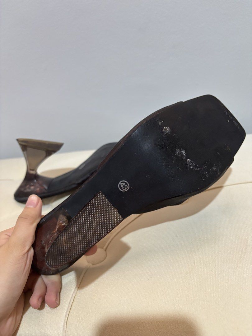 Black Heeled Mules with Clear Unique Heel Size 43 (Category: Heels) located in Quezon City. Submitted by hadescloset (Listing ID 1468394763, Image 3). Description: - Style: Black mules with open square toes and wide strap - Heel: Unique translucent brownish sculptured heel - Material: Smooth fabric upper - Size: 43 - Condition: Minor scuffs on the sole from wearing outside, overall good pre-loved condition.