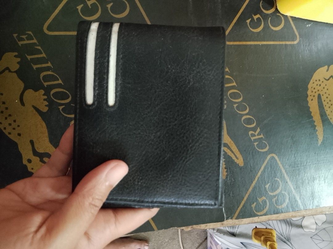 Black Leather Bifold Wallet with White Stripes (Category: Wallets & Card Holders) located in Manila. Submitted by amiarnajea96023 (Listing ID 1468328758, Image 1). Description: - Material: Premium black leather - Design: Stylish double vertical white stripes on the front - Storage: Multiple card slots and a spacious main cash compartment - Size: Standard men's bifold size, compact and pocket-friendly - Condition: Brand new and ready for everyday 